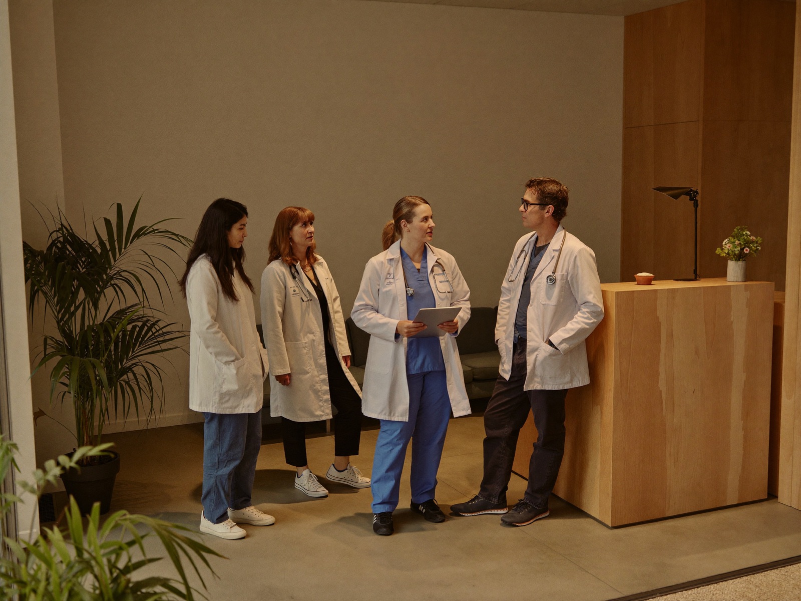 A team of doctors talking together in a modern practice reception